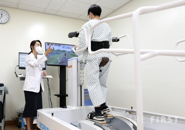 유지현 일산백병원 재활의학과 교수가 발판구동형 재활 로봇을 활용한 로봇보조 보행 치료 방법을 설명하고 있다.